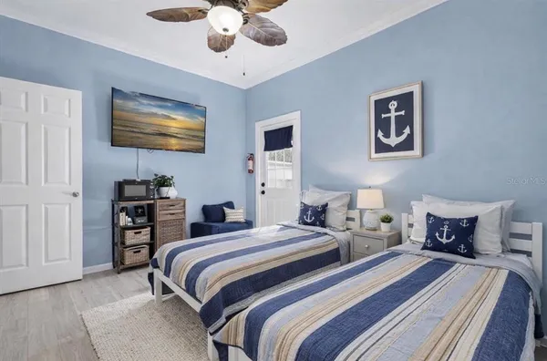 a bedroom with a large bed and a chandelier