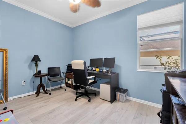 a view of a workspace with furniture and a window