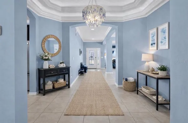 a living room with furniture and a chandelier