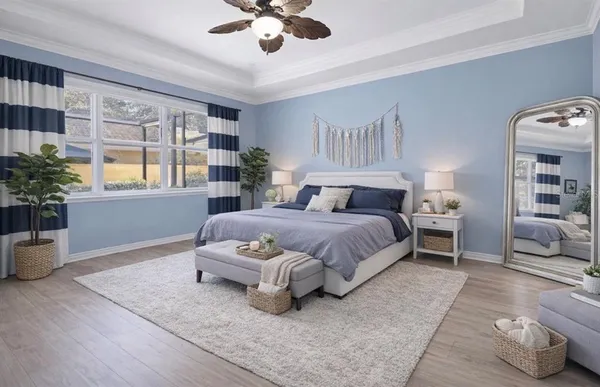 a spacious bedroom with a large bed and a potted plant