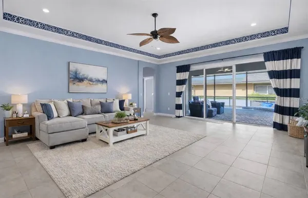 a living room with furniture and a chandelier