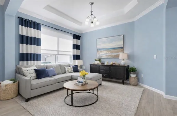 a living room with furniture and a chandelier