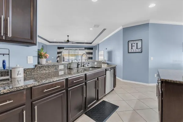 a kitchen with granite countertop a sink and a stove