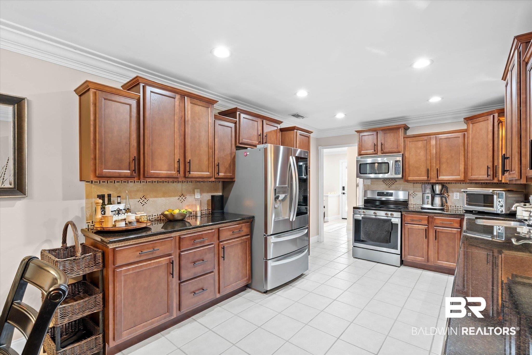 101 Ann Street Daphne, AL 36527 - Photo 12 of 38 Kitchen featuring wood cabinetry, stainless steel appliances, dark countertops, white tile flooring, and recessed lighting