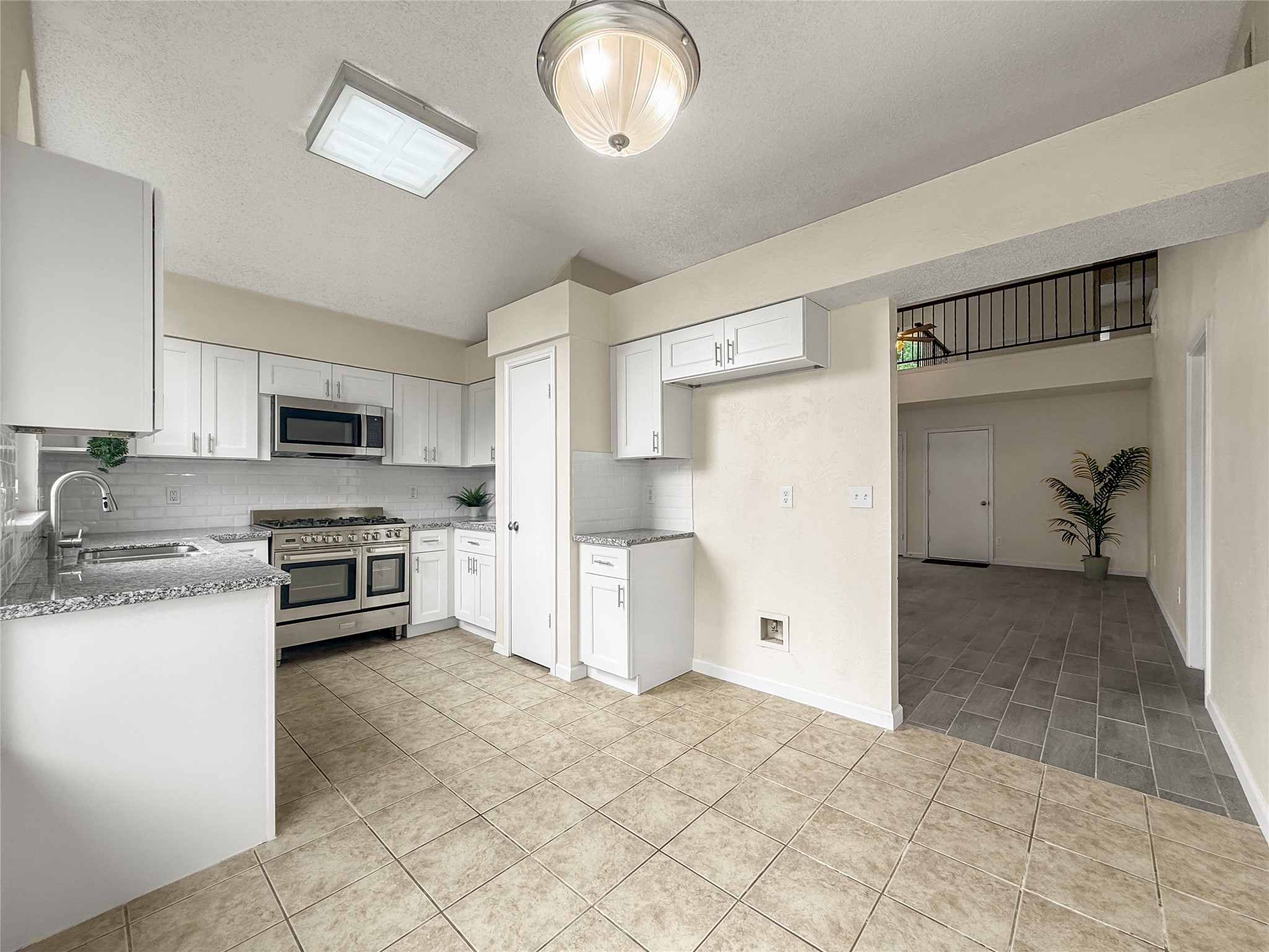 13635 Repa Lane Houston, TX 77014 - Photo 16 of 48 The stainless steel gas range with double ovens, a built-in microwave are perfect for culinary enthusiasts!