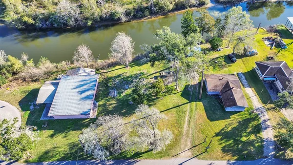 an aerial view of a house with a lake view