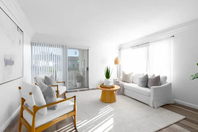 a living room with furniture and a potted plant