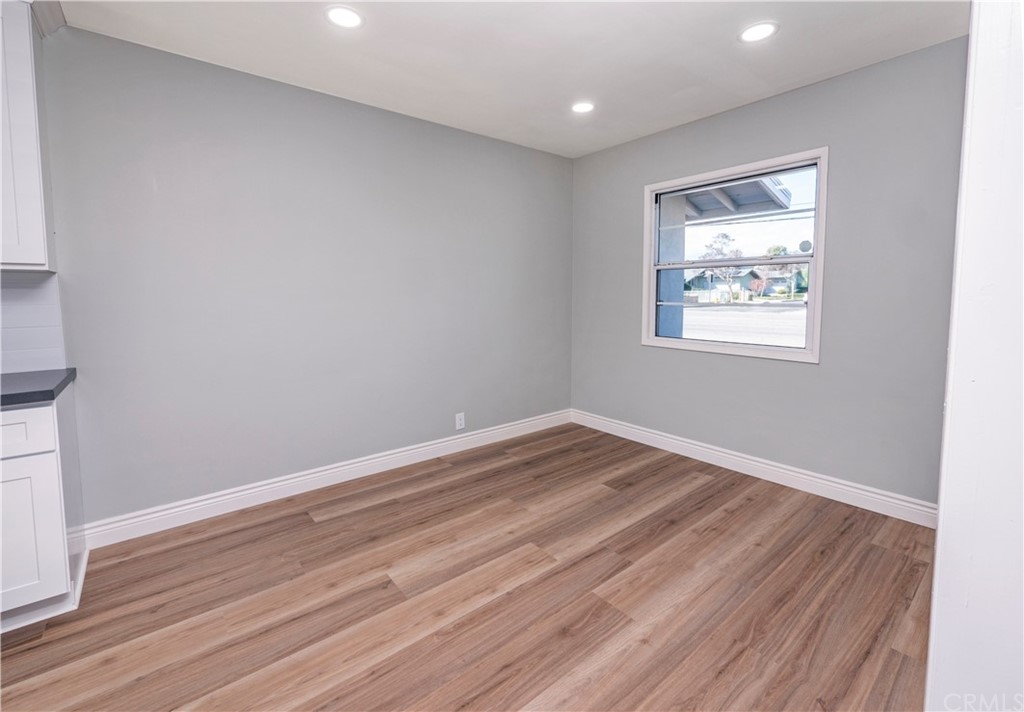 150 East Gladstone Street San Dimas, CA 91773 - Photo 11 of 37 an empty room with wooden floor and windows