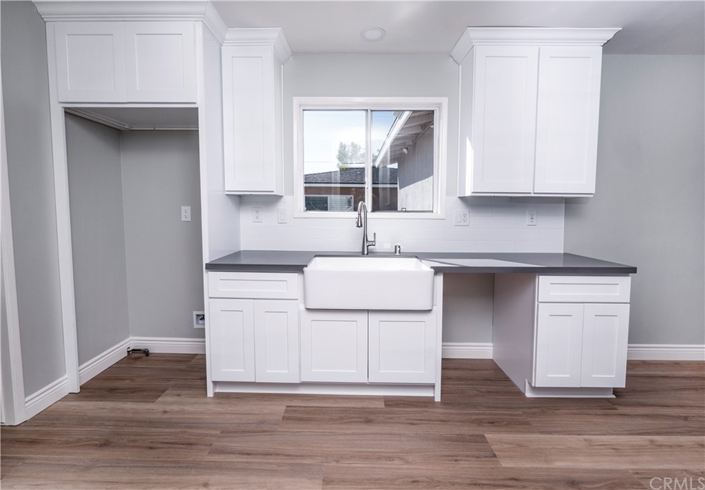 150 East Gladstone Street San Dimas, CA 91773 - Photo 14 of 37 a kitchen with white cabinets and sink