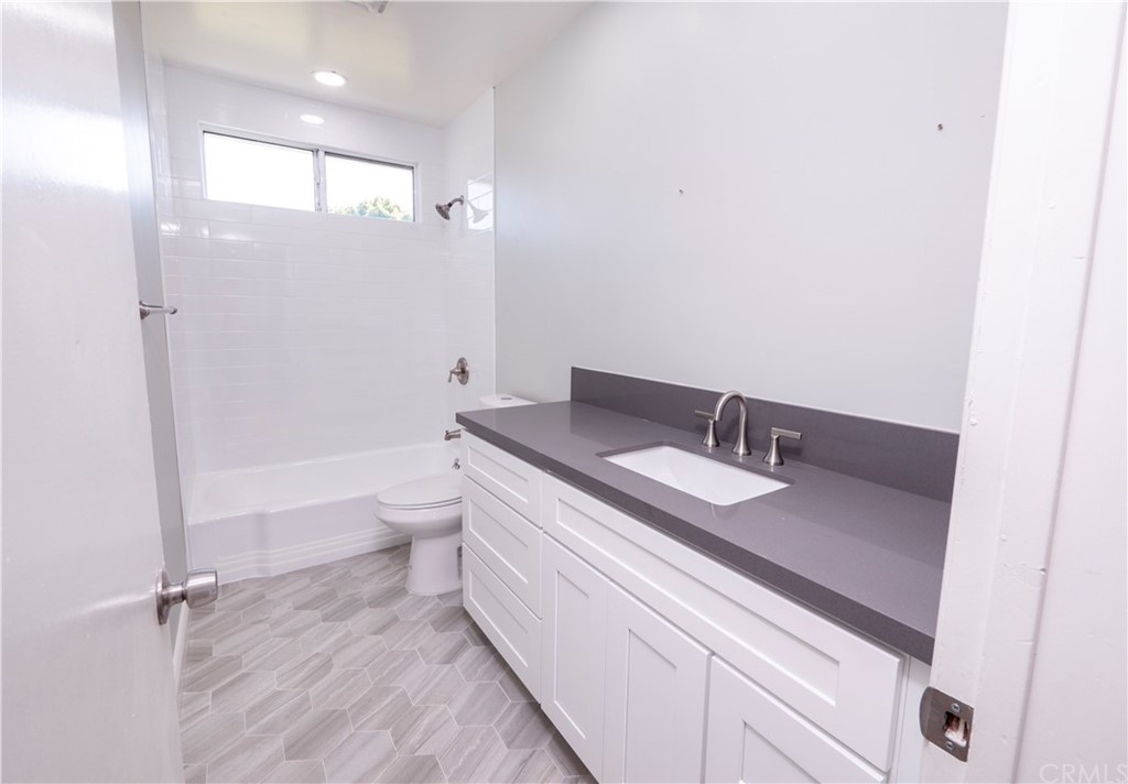 150 East Gladstone Street San Dimas, CA 91773 - Photo 18 of 37 a bathroom with a granite countertop sink mirror vanity and toilet