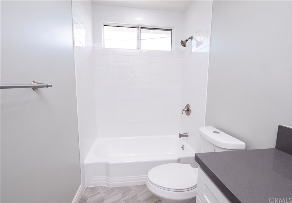 150 East Gladstone Street San Dimas, CA 91773 - Photo 19 of 37 a white toilet sitting next to a bath tub