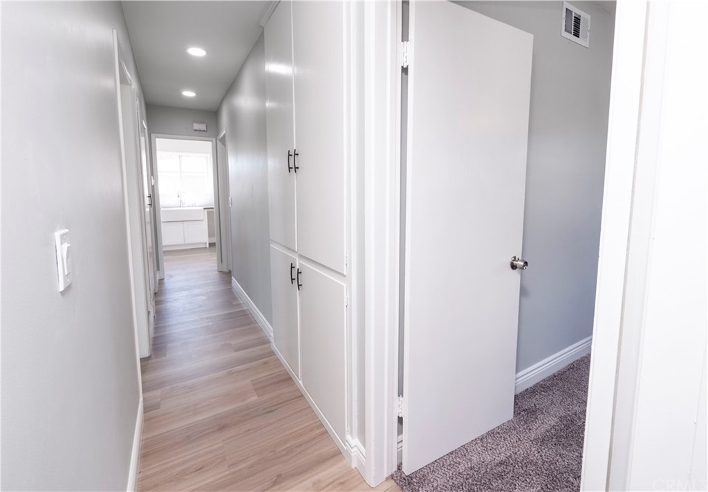 150 East Gladstone Street San Dimas, CA 91773 - Photo 23 of 37 a view of a hallway with the wooden floor