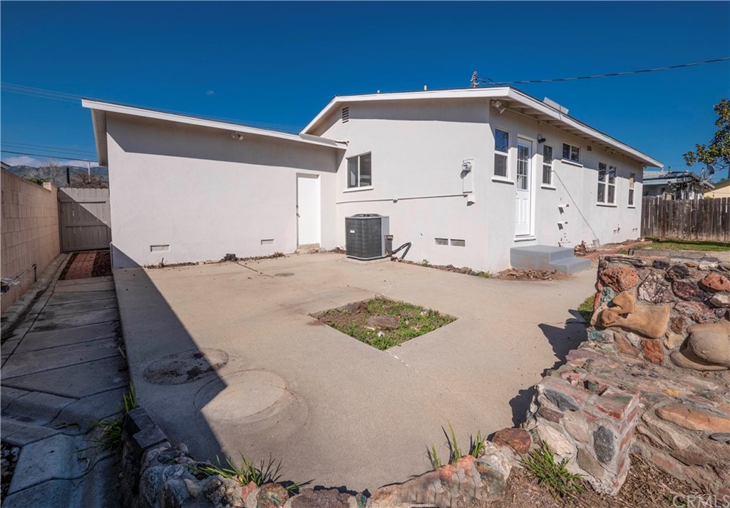 150 East Gladstone Street San Dimas, CA 91773 - Photo 31 of 37 a view of a white house with a yard