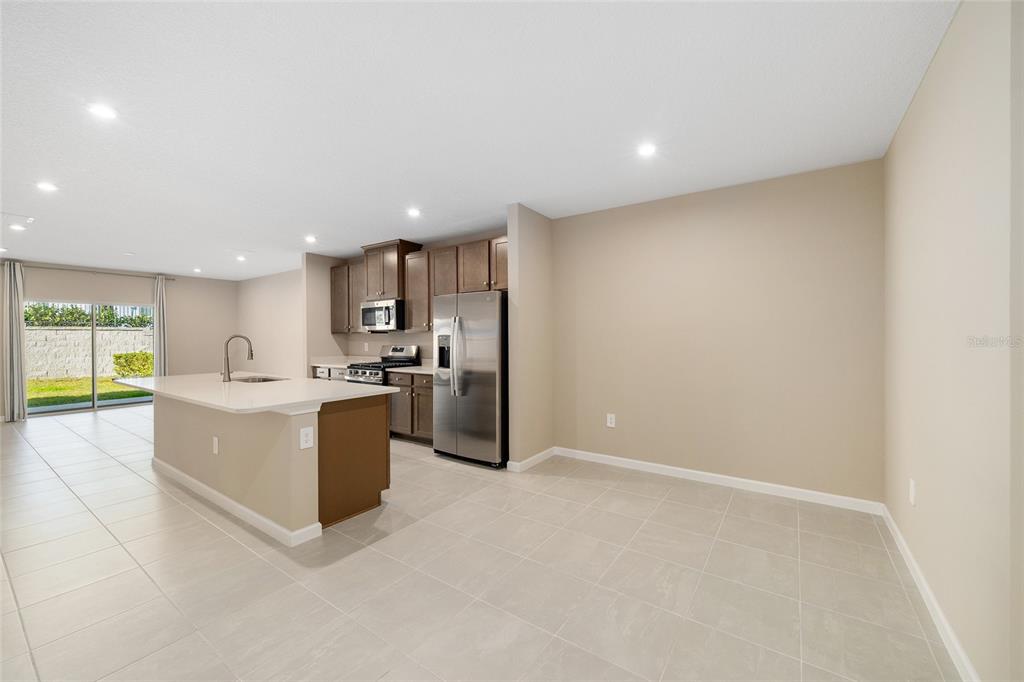 1183 Turtle Is Road Lady Lake, FL 32159 - Photo 12 of 39 a large white kitchen with a sink a window and stainless steel appliances