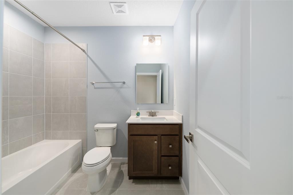1183 Turtle Is Road Lady Lake, FL 32159 - Photo 27 of 39 a bathroom with a sink a toilet and shower