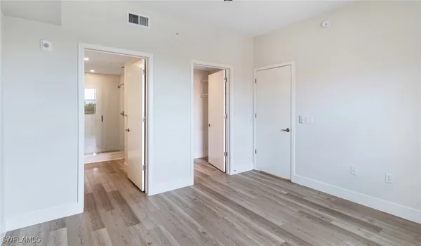 a view of a room with wooden floor