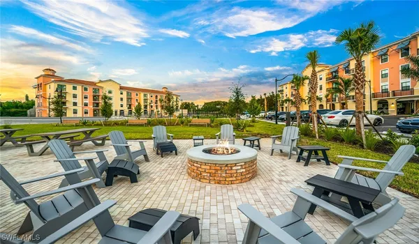 a view of a chairs and table in patio with a lake view