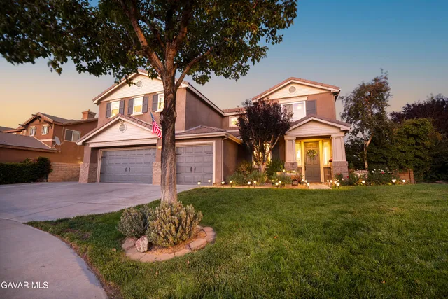a front view of a house with a garden and yard