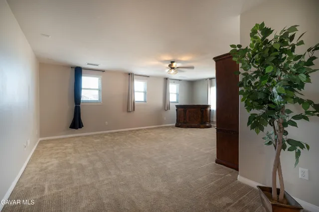 a view of empty room with window and front door