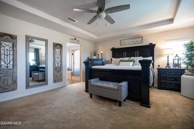 a bedroom with furniture and a ceiling fan