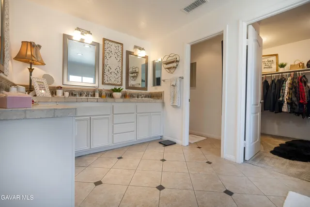 a bathroom with a double vanity sink a mirror and a shower