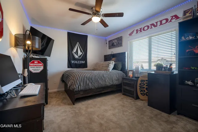 a bedroom with a bed and a flat tv screen