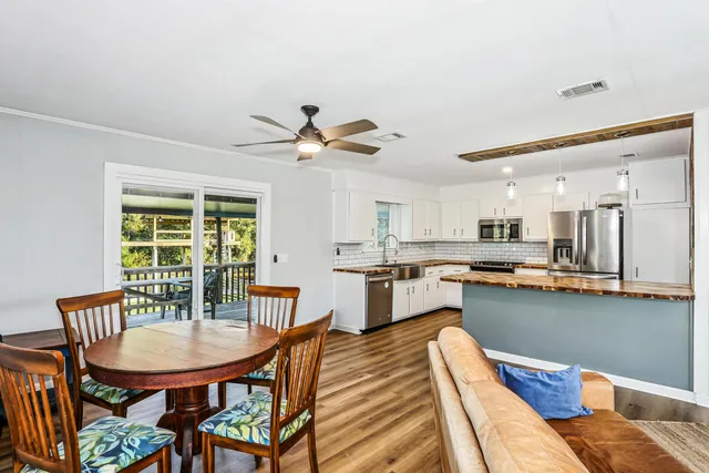 a view of a dining room with furniture and window