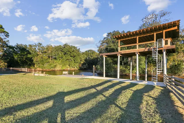 a view of a house with swimming pool and sitting area