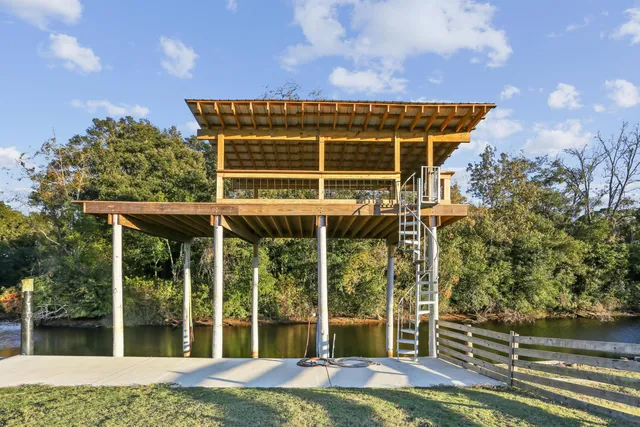 a view of house with backyard and glass windows
