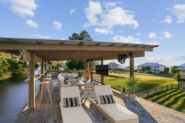 a view of a patio with chairs and a table with potted plants
