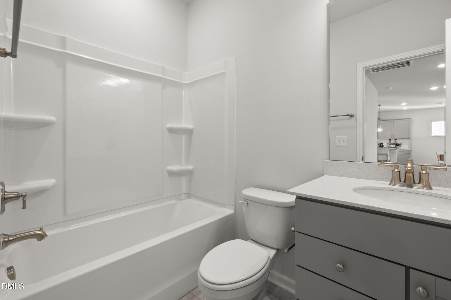 204 Armorial Court Willow Spring, NC 27592 - Photo 20 of 26 a bathroom with a sink a toilet and a bathtub