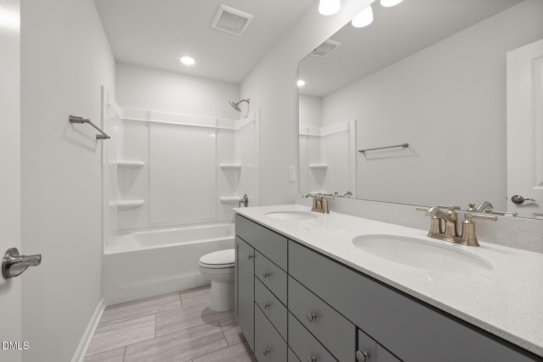 204 Armorial Court Willow Spring, NC 27592 - Photo 25 of 26 a bathroom with a sink a toilet and shower