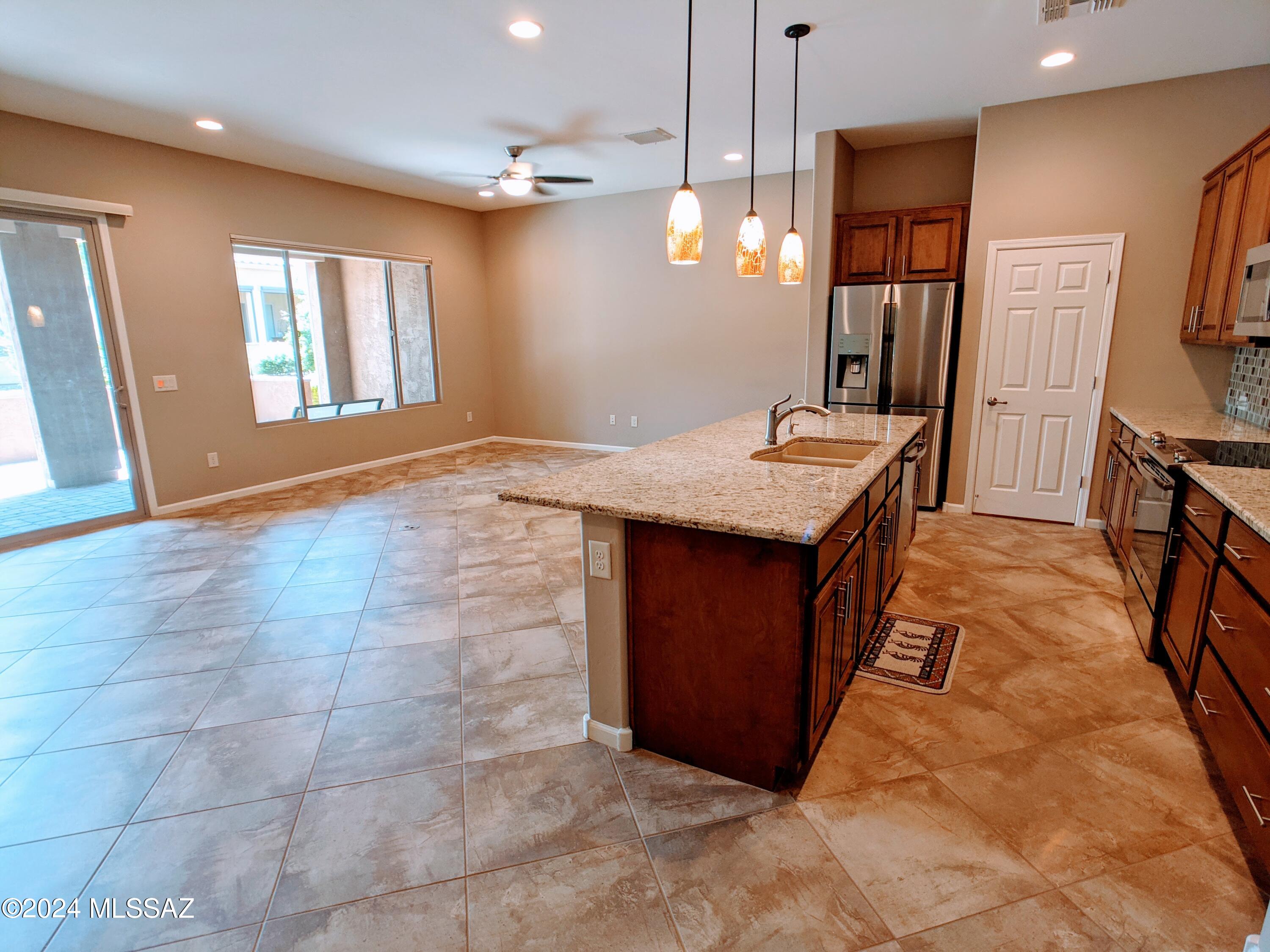 61021 East Slate Road Oracle, AZ 85623 - Photo 8 of 18 a very nice looking kitchen with a stove a sink a counter space and a window