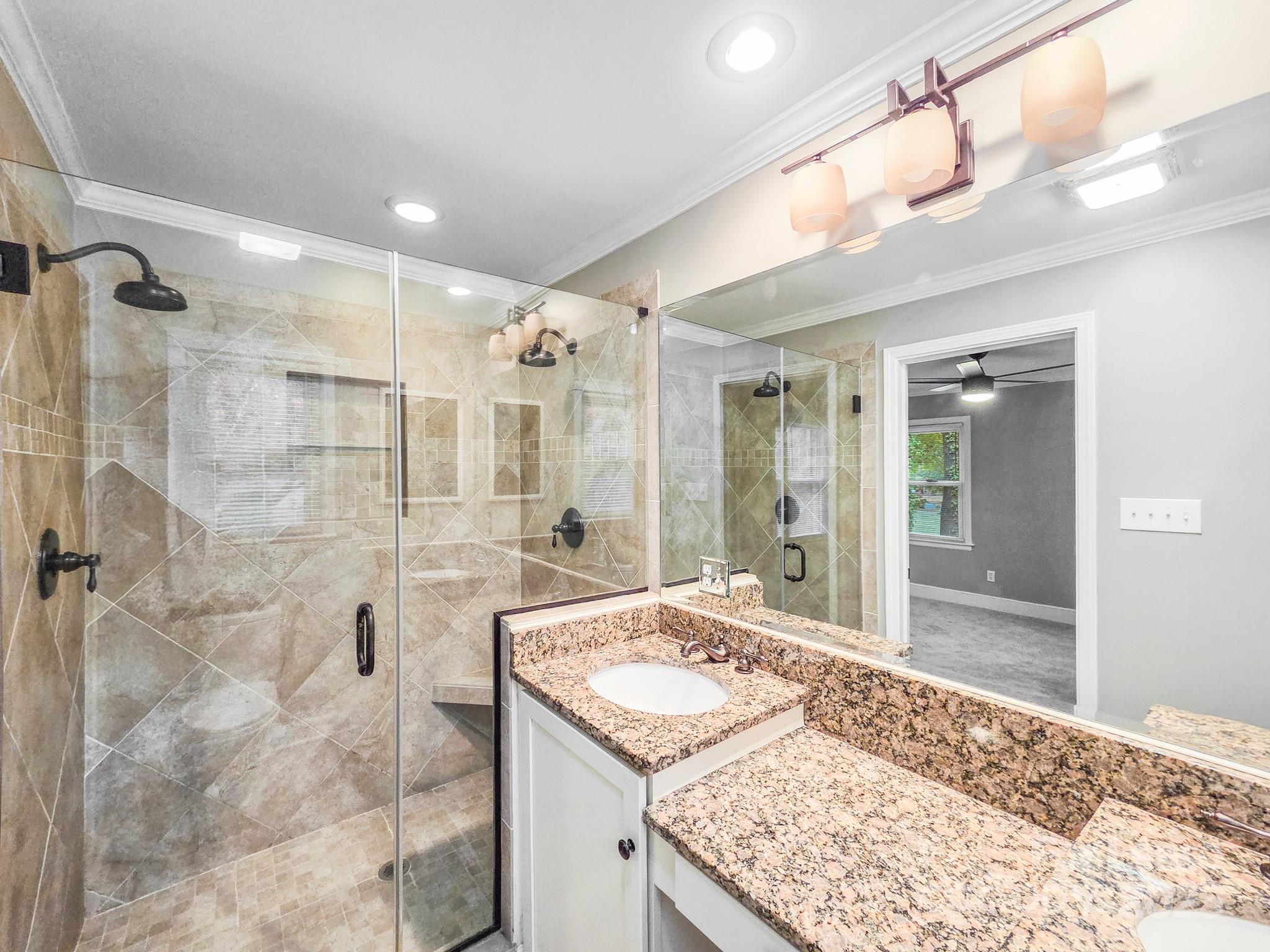 5600 Riviere Drive Charlotte, NC 28211 - Photo 19 of 35 a bathroom with a granite countertop sink mirror and shower