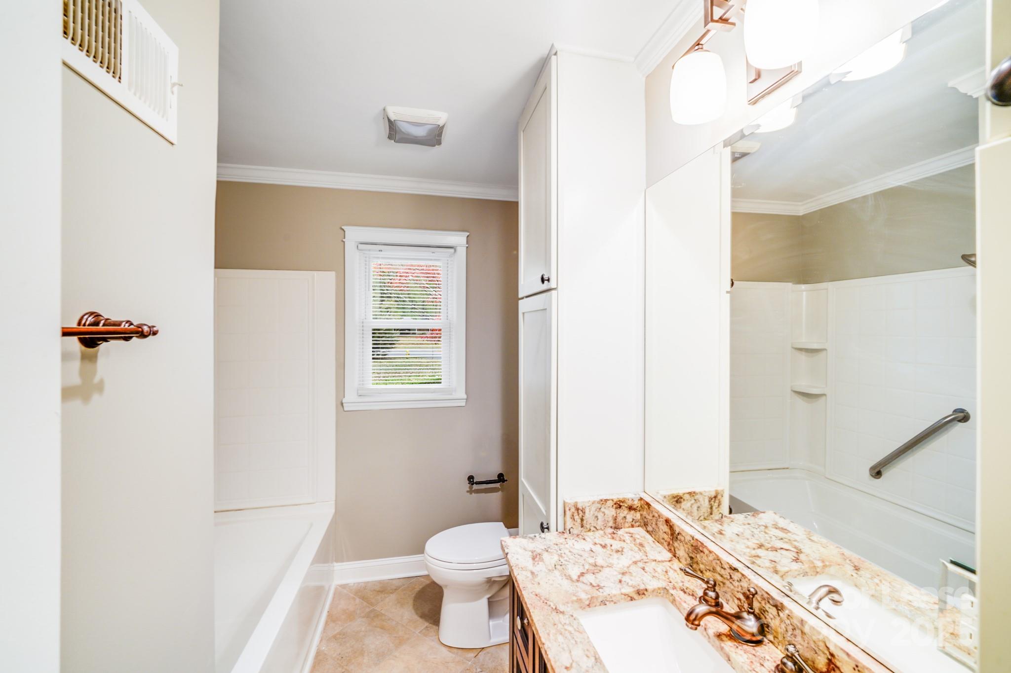 5600 Riviere Drive Charlotte, NC 28211 - Photo 20 of 35 a bathroom with a sink and a mirror