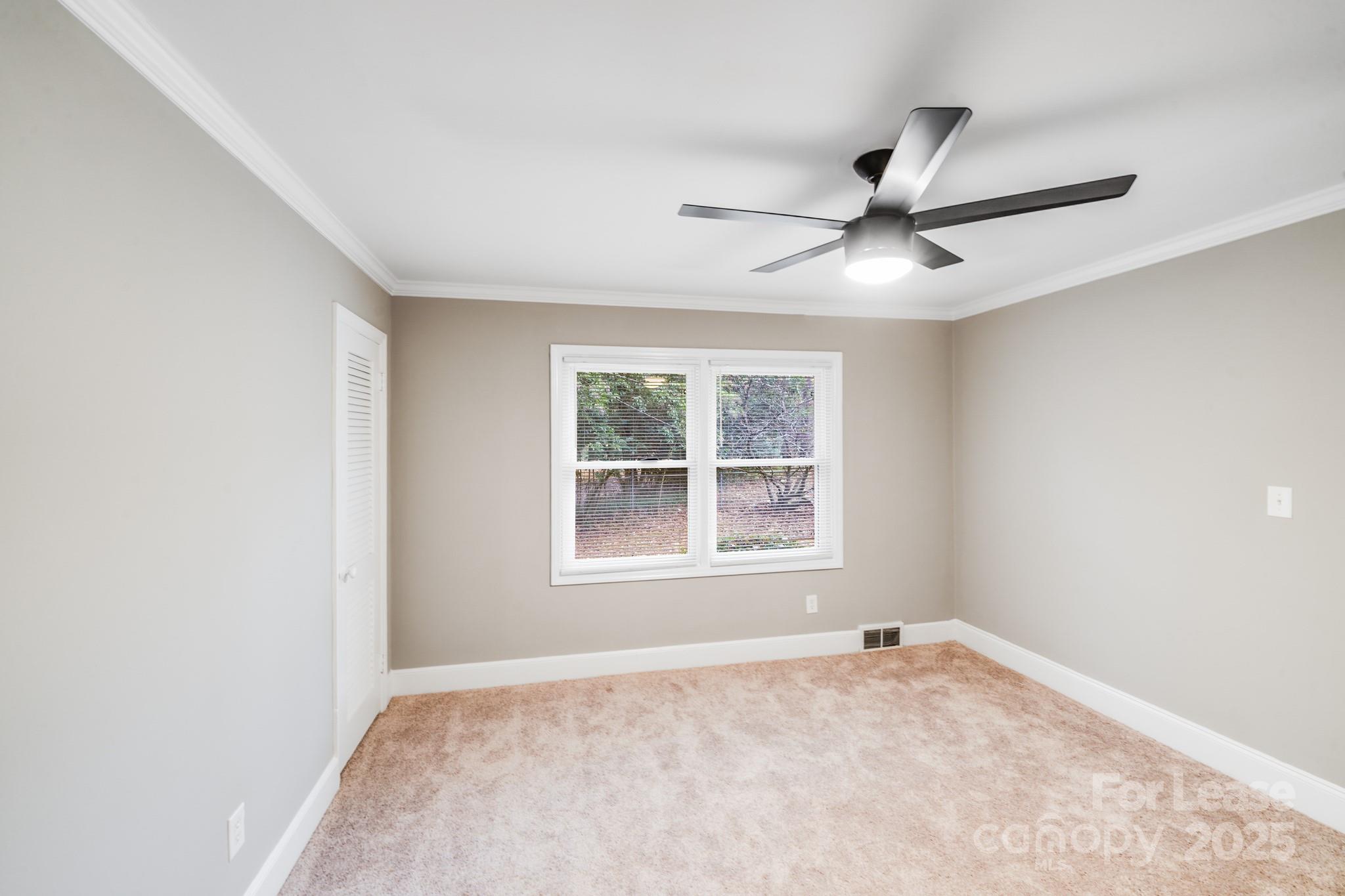 5600 Riviere Drive Charlotte, NC 28211 - Photo 24 of 35 an empty room with a window and a fan