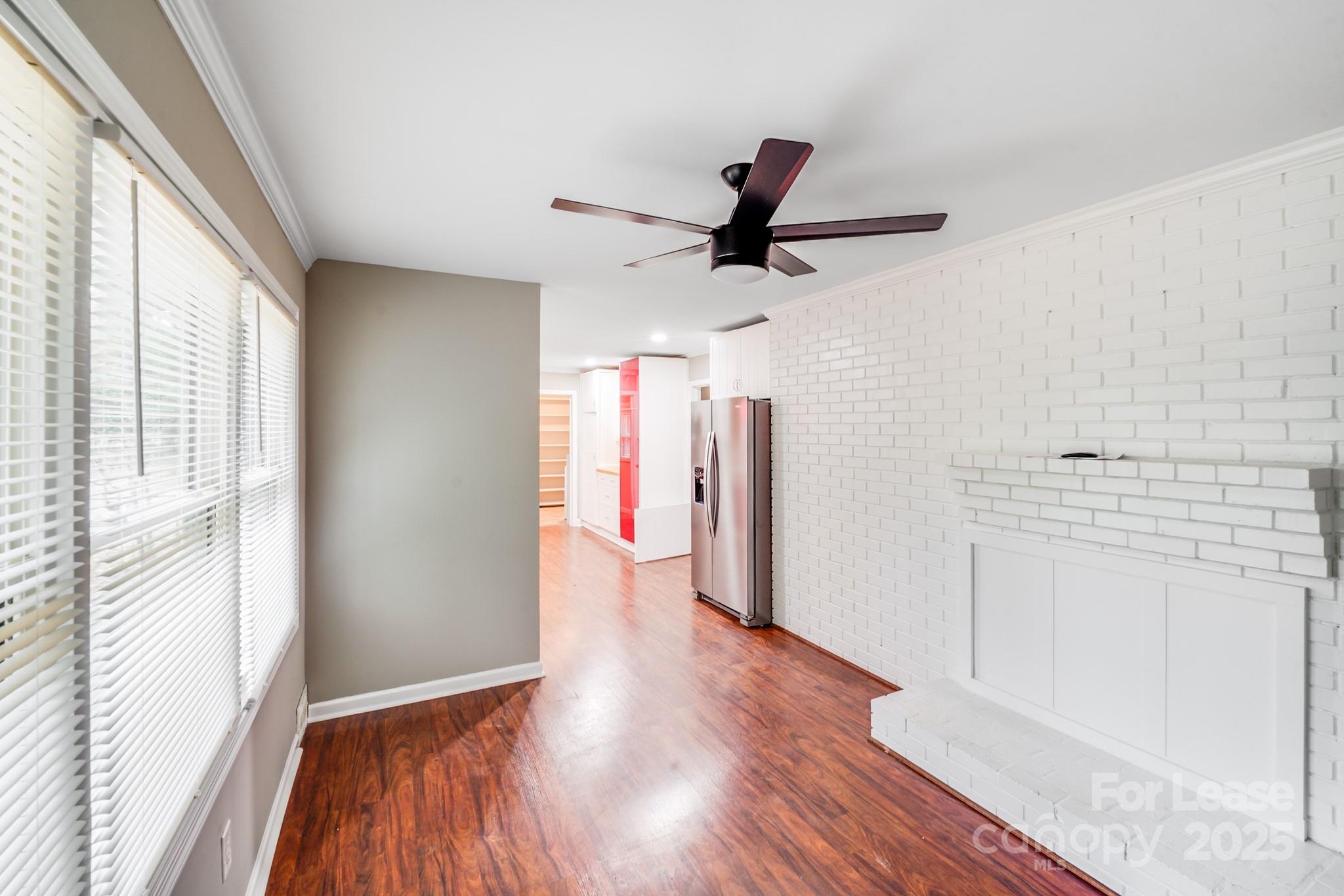 5600 Riviere Drive Charlotte, NC 28211 - Photo 4 of 35 a view of empty room with wooden floor and window
