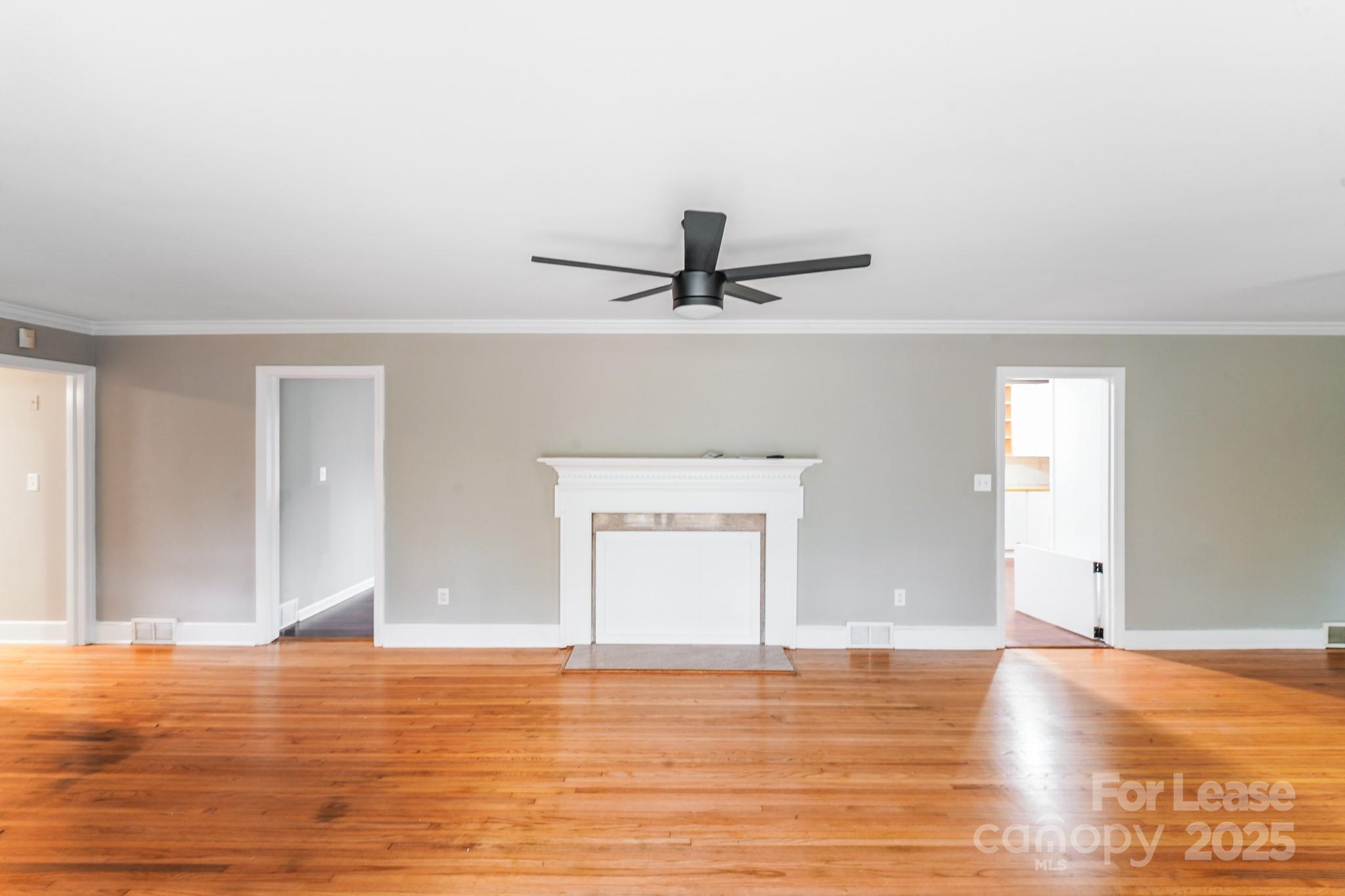 5600 Riviere Drive Charlotte, NC 28211 - Photo 10 of 35 a view of a room with wooden floor and white walls