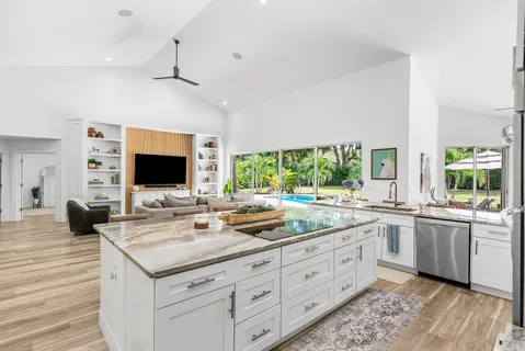 a open kitchen with stainless steel appliances granite countertop a sink and dishwasher with wooden floor