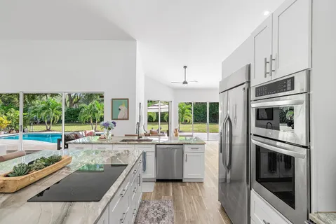 a kitchen with stainless steel appliances granite countertop a stove and a sink