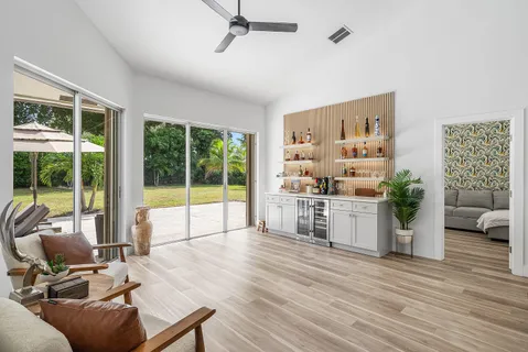 a living room with furniture and large windows