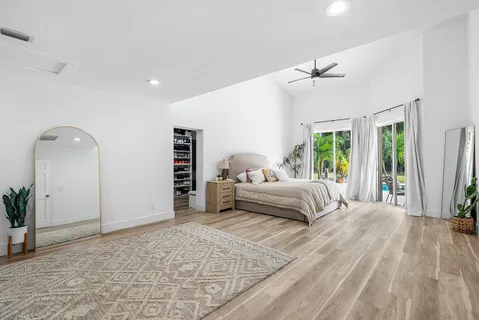 a spacious bedroom with a large bed and a window