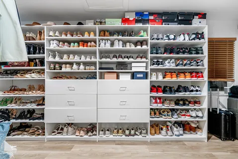 a view of a hallway with wooden floor and windows