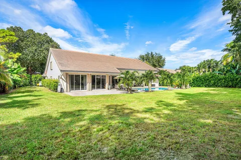 a view of a swimming pool with a yard