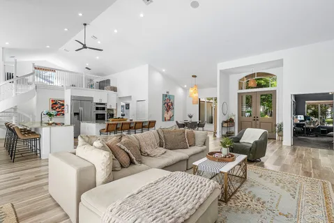 a living room with furniture and a chandelier
