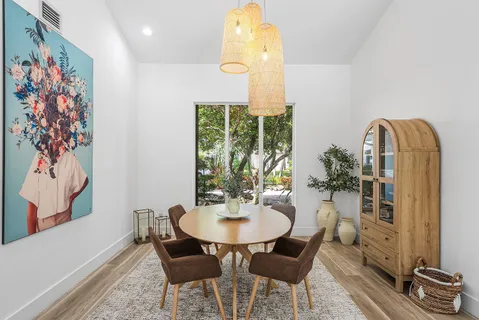 a dining room with furniture and wooden floor