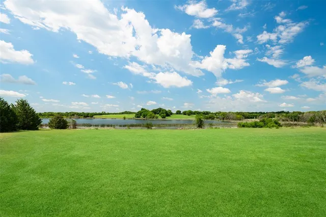 a view of a lake with a yard