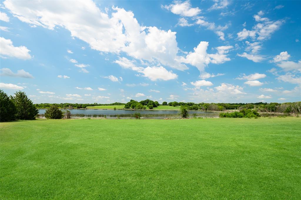 318 Cold Springs Road Van Alstyne, TX 75495 - Photo 11 of 17 a view of a lake with a yard
