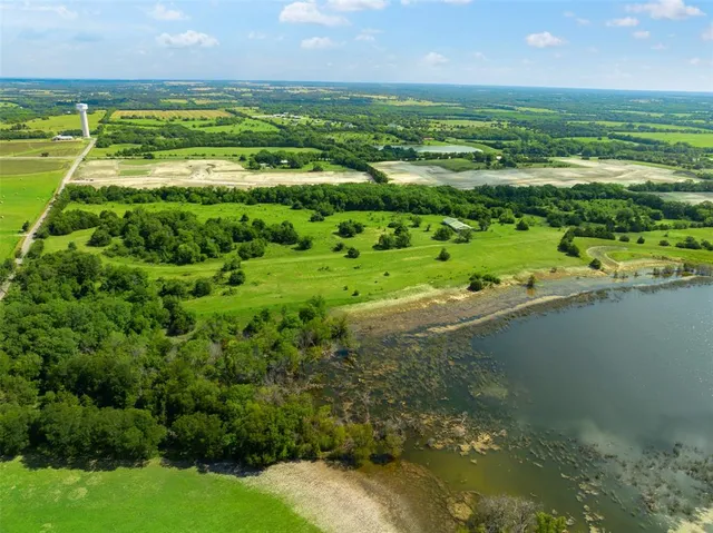 a view of a field with an ocean