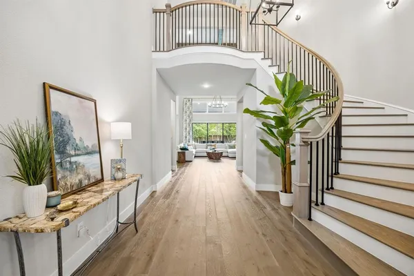 a hallway with a dining table chairs and a chandelier